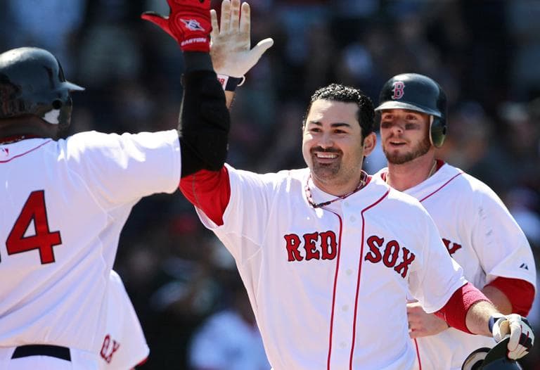 Boston Red Sox&#039;s Adrian Gonzalez, center, celebrates his two-run home run in the fourth inning against the Oakland Athletics on Sunday. (AP)