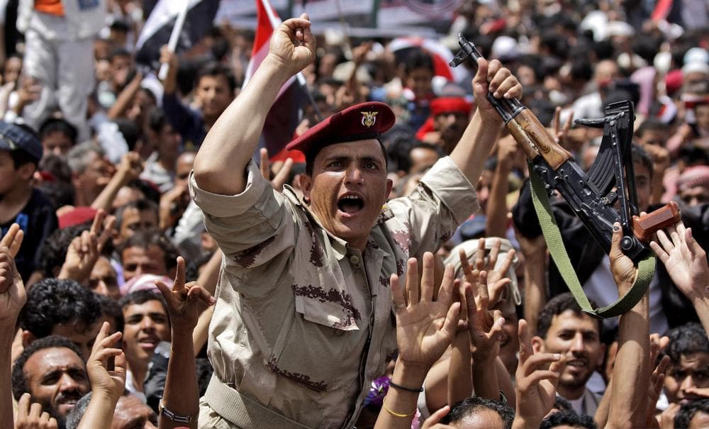 A Yemeni army officer lifted by anti-government protesters, chants slogans as he and others celebrate in Sanaa President Ali Abdullah Saleh's departure for medical treatment. (AP)