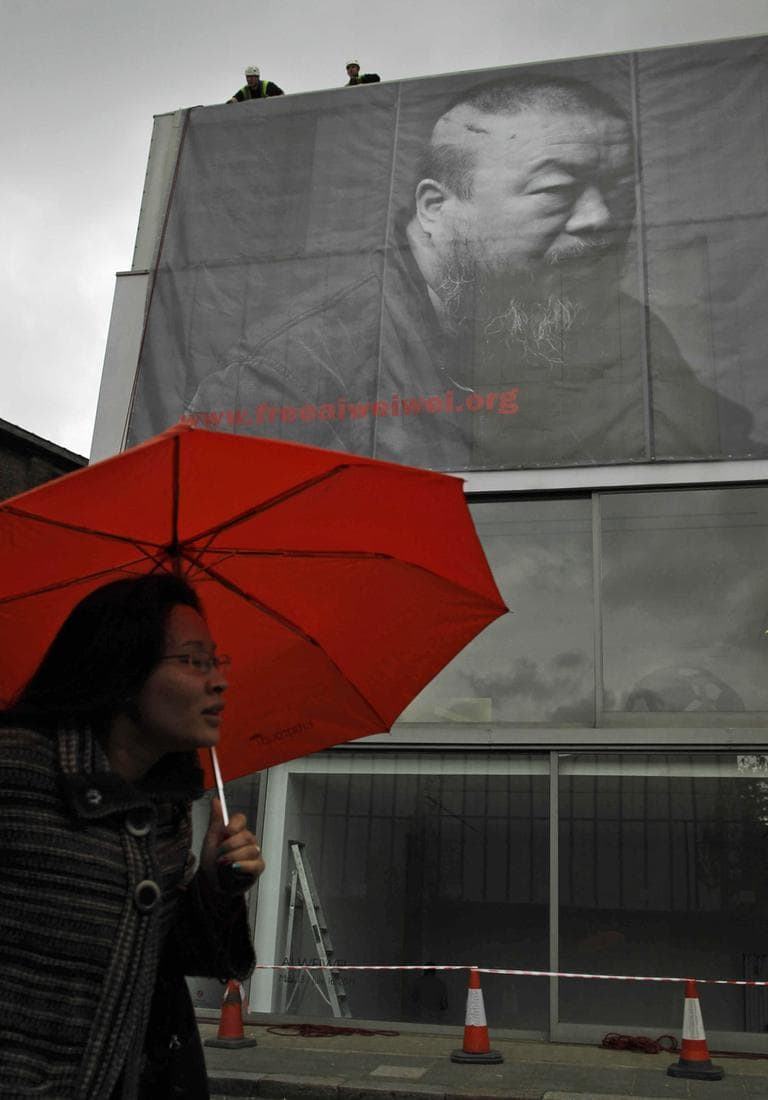 This image shows a two-story-high black-and-white photograph of Chinese artist Ai Weiwei outside the Lisson Gallery in London. (AP)