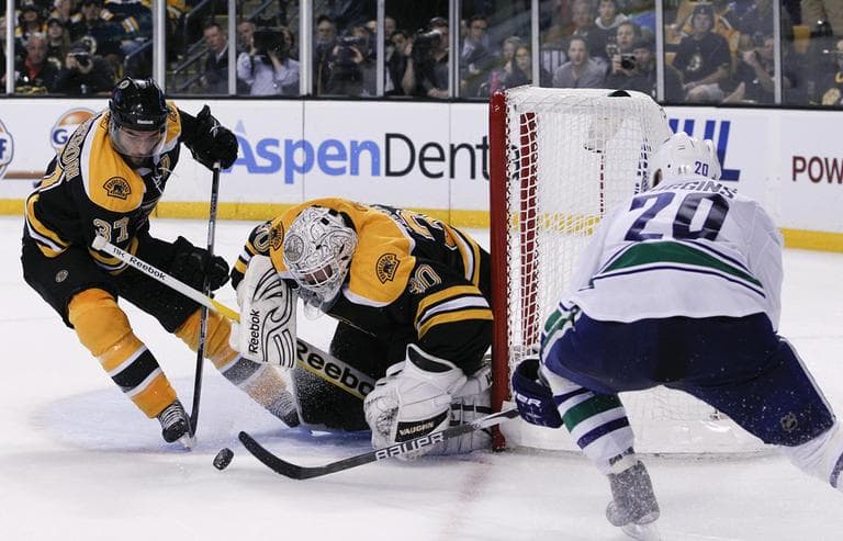 Bruins goalie Tim Thomas (30) makes a save on a shot by Canucks left wing Christopher Higgins (20) during Game 3 of the Stanley Cup Finals, Monday. (AP)