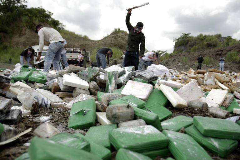 Panama City police cut open packages of cocaine before burning narcotics during a drug disposal operation in May 20, 2011. Officials said they burned 6.5 tons of drugs, including cocaine, marijuana, heroin and ecstasy. (AP)
