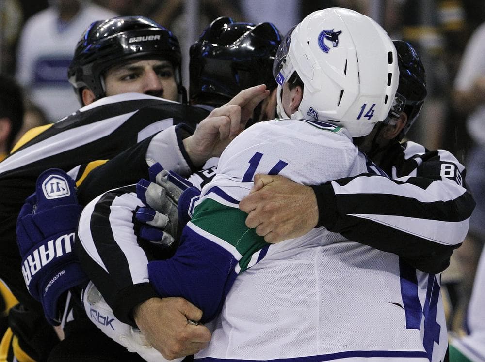 Boston Bruins Milan Lucic challenges Vancouver Canucks Alex Burrows to bite his fingers during a scuffle in Game 3 of the Stanley Cup Finals, Monday. (AP)