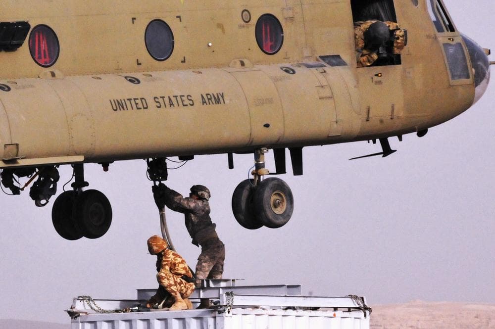 Soldiers from Combined Team Zabul sling-load a container of components for a cell phone tower on March 25, 2011, in Kandahar province. The American military is building an independent cell phone network in Afghanistan to prevent the Taliban from shutting down cell phone communication. (AP)