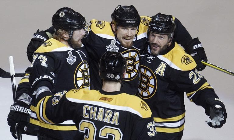 Bruins defenseman Andrew Ference, center, celebrates his  Game 6 goal against the Vancouver Canucks with Michael Ryder, left, Mark Recchi, right, and Zdeno Chara. (AP)