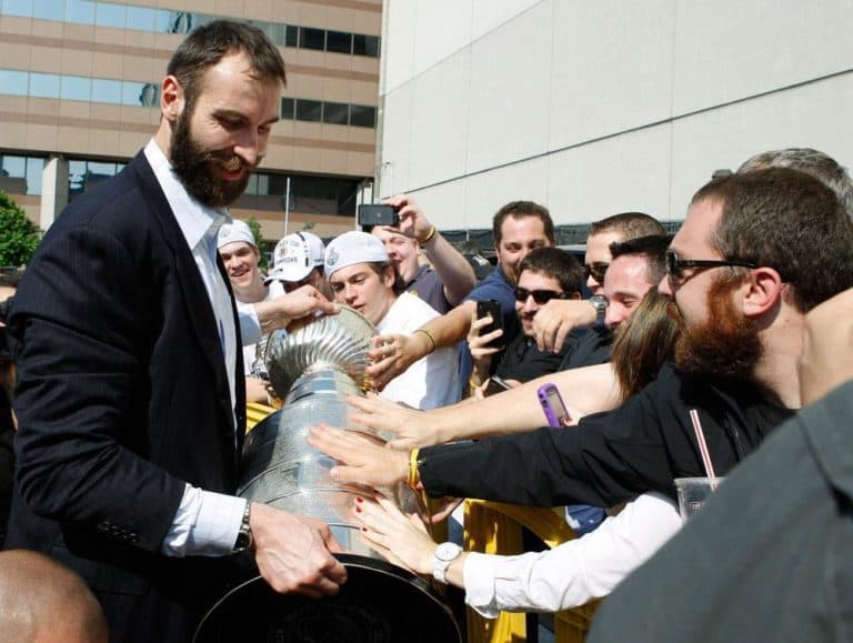Bruins Captain Zdano Chara held the Stanley Cup as he greeted fans back in Boston. (AP)