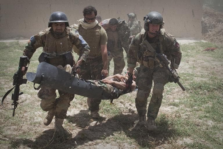 Afghan National Army soldiers and US Marines rush with badly wounded Afghan Army soldiers to a a medevac helicopter. (AP)