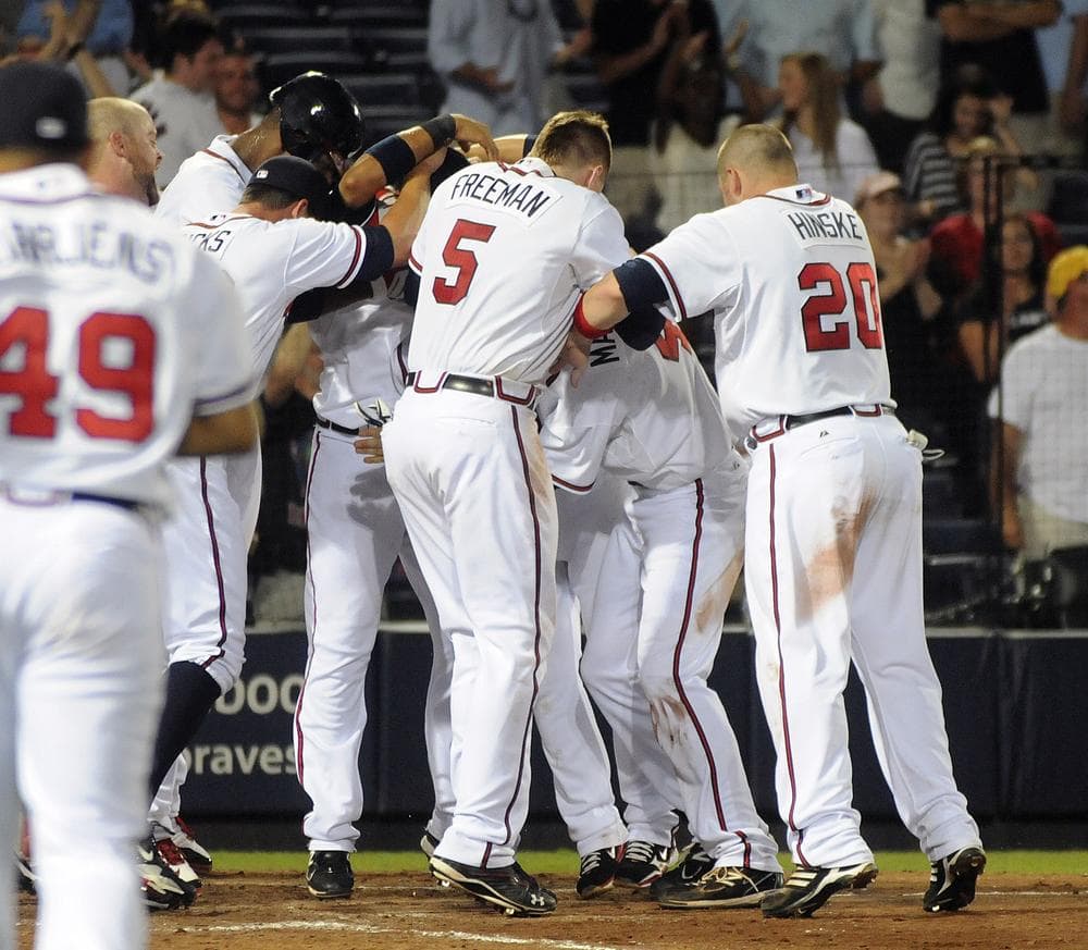 Atlanta Braves celebrate their extra innings victory over the New York Mets after D.J. Carrasco balked in the winning run in the 10th inning Thursday in Atlanta. (AP)