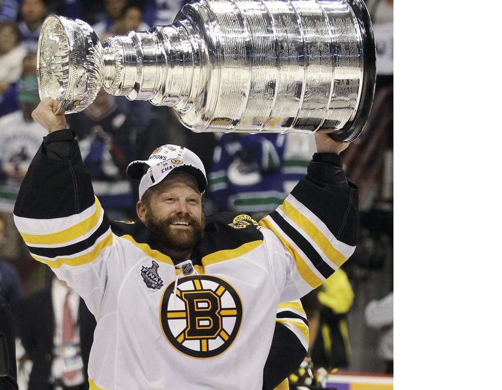 Boston Bruins Tim Thomas hoists the Stanley Cup after defeating the Vancouver Canucks to win the Stanley Cup Finals. (AP)