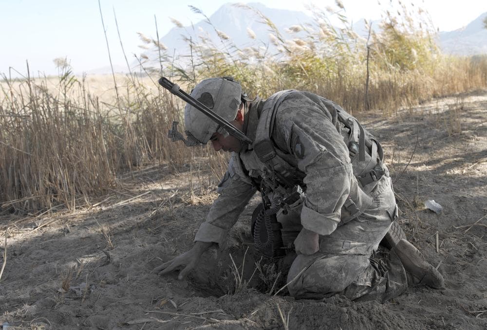 US Army Spc. Francisco Liquet from First Battalion, 502nd Infantry Regiment, 101st Airborne Division looks for an IED during a patrol in Panjwai district, Afghanistan's Kandahar province in 2010. (AP)