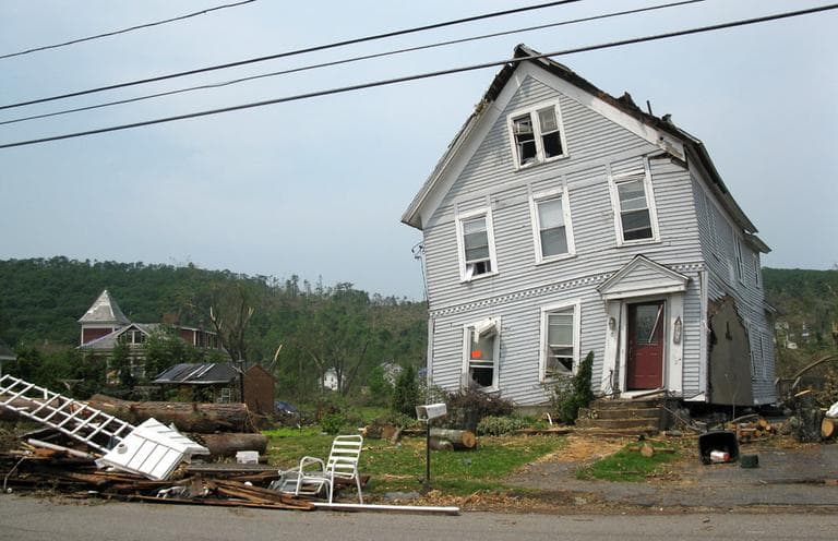 A Monson house is marked to be torn down after it was twisted by this month's tornado. (Fred Thys/WBUR)