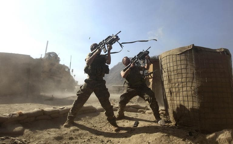 Spc. Charles Moore and Spc Andrew Vanderhaeghen return fire upon a sudden attack by Taliban on Combat Outpost Badel in  Afghanistan near Pakistan border. What if all the troops came home? (AP)