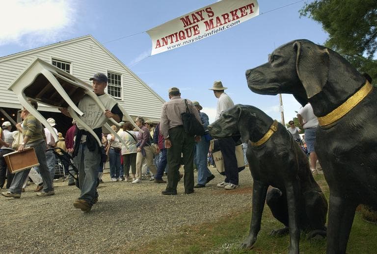 A pair of cast bronze hounds appear to stand guard at the Antique Market in Brimfield, Mass. (AP)