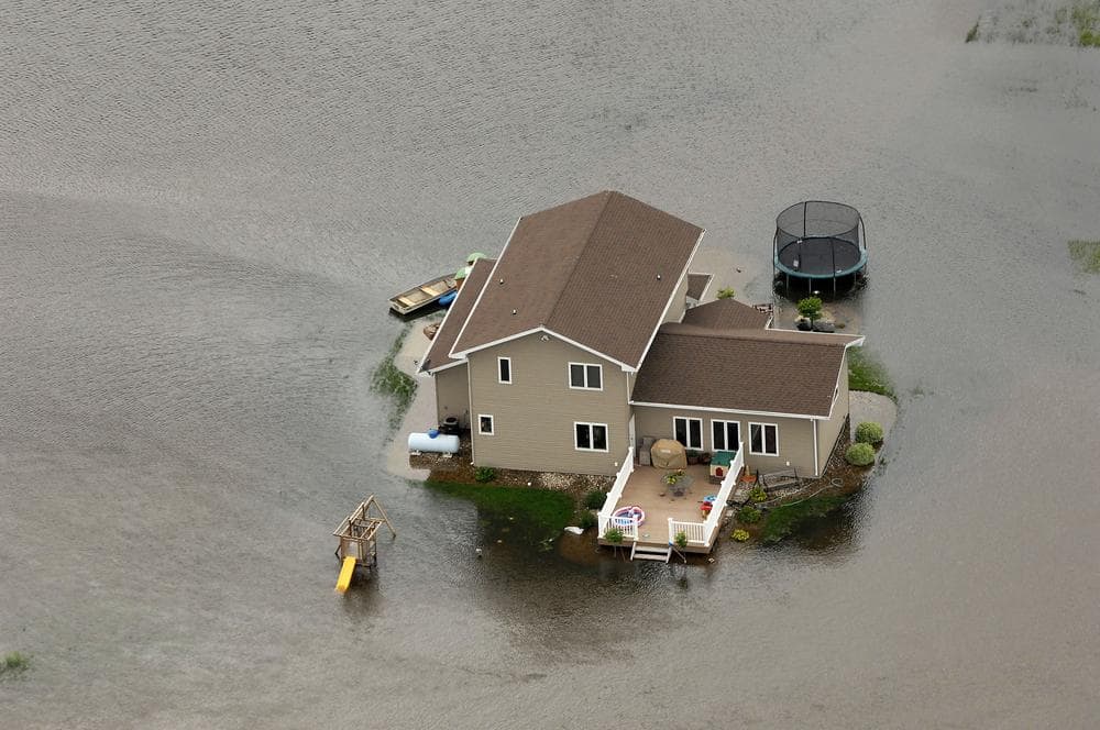 A home is surrounded by water near Minot, N,D. on Wednesday. (AP)