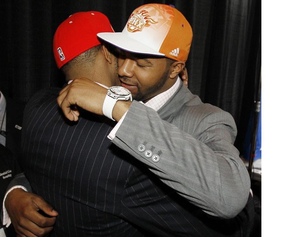 Twin brothers Markieff Morris and Marcus Morris embrace each other after they were picked No. 13 and No. 14 during the NBA basketball draft, Thursday. (AP)