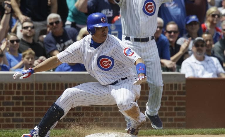Chicago Cubs' Kosuke Fukudome is safe at third base after hitting an one-run triple against the Milwaukee Brewers. (AP)