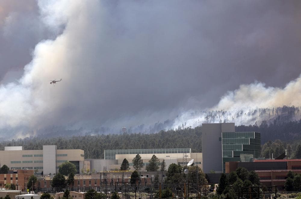 A helicopter flies over the Los Alamos Laboratory as smoke rises from the Las Conchas fire in Los Alamos, N.M., Wednesdaya. (AP)