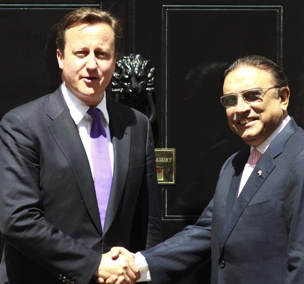 Britain's Prime Minister David Cameron, left, poses for pictures with Pakistan's President Asif Ali Zardari as he welcomes him outside his official residence at 10 Downing street Street in London. (AP)