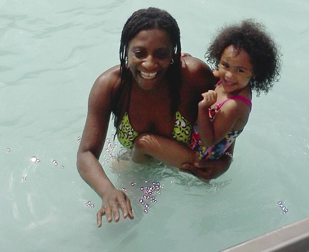 Marie Joseph, 36, holding a family friend's daughter, in the public swimming pool at Lafayette Park in Fall River, Mass. Joseph's body was found floating in the pool late Tuesday. (AP)