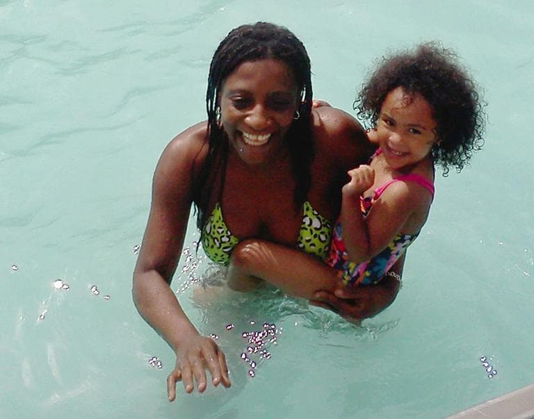 In this photo provided by Candella Matta, Marie Joseph holds a family friend&#039;s daughter in the public swimming pool at Lafayette Park in Fall River. (AP)