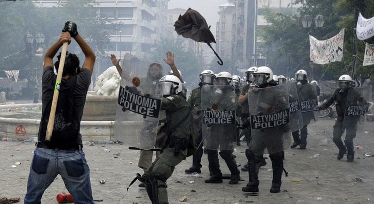 Greece approved more austerity measures needed to avert default next month, that calmed markets but triggered a second day of riots that left dozens injured. (AP)