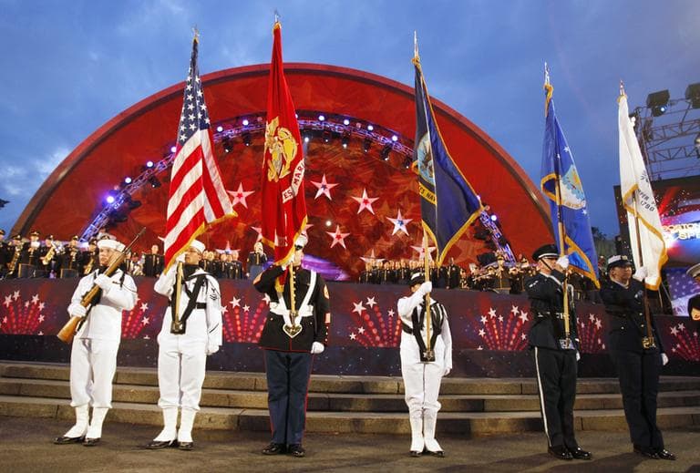 A military color guard stands ready for the playing of the National Anthem during the Boston Pops July Fourth concert rehearsal on Sunday. (AP)