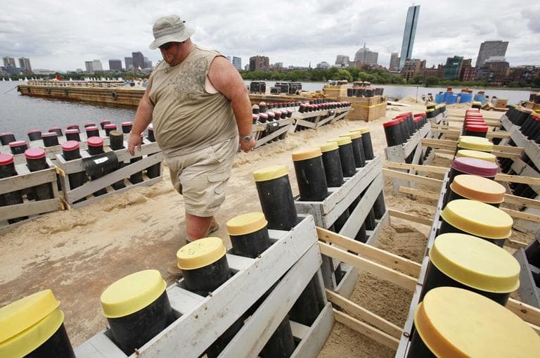 A pyrotechnic crew prepares fireworks launchers on a barge on the Charles River for Boston&#039;s annual Fourth of July celebrations. (AP) 