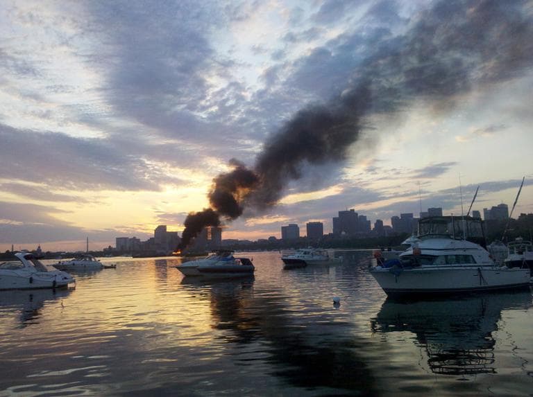 The fire was spotted at about 5 a.m. on Tuesday on the barge that fired off Boston’s July Fourth fireworks Monday night. (Rachel Rohr/WBUR)