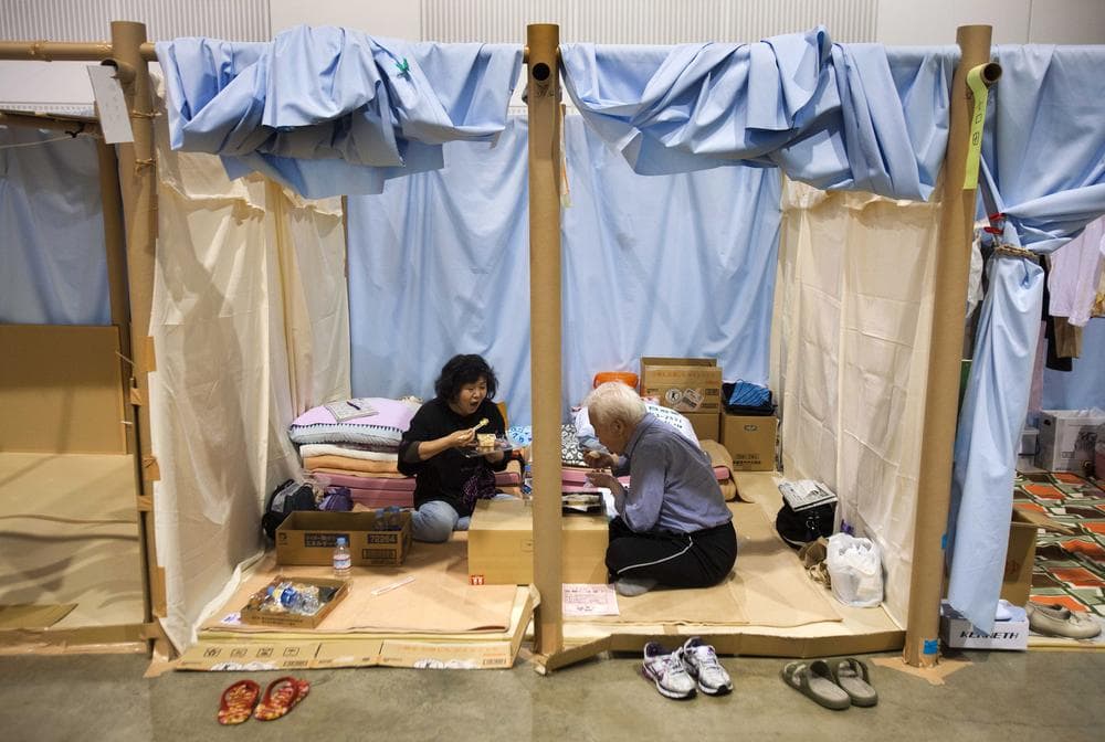 A Japanese refugee couple eat their dinner in their allotted space at an arena used as evacuation center in Koriyama, Fukushima prefecture, northeastern Japan in late May. (AP)