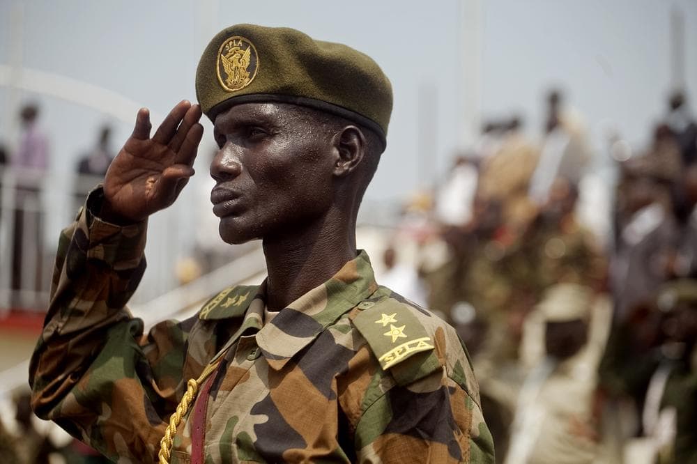 A Southern Sudanese soldier listens to the national anthem during an independence rehearsal procession in Juba, southern Sudan on Thursday. (AP)