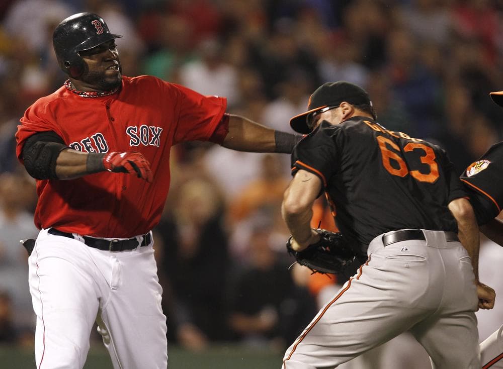 David Ortiz takes a swing at Baltimore Orioles relief pitcher Kevin Gregg after they exchanged words after Ortiz flied out during the eighth inning. (AP) 