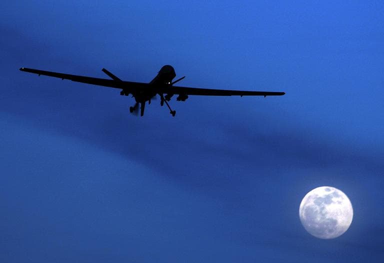 A U.S. Predator drone flies over the moon above Kandahar Air Field, southern Afghanistan. (AP)