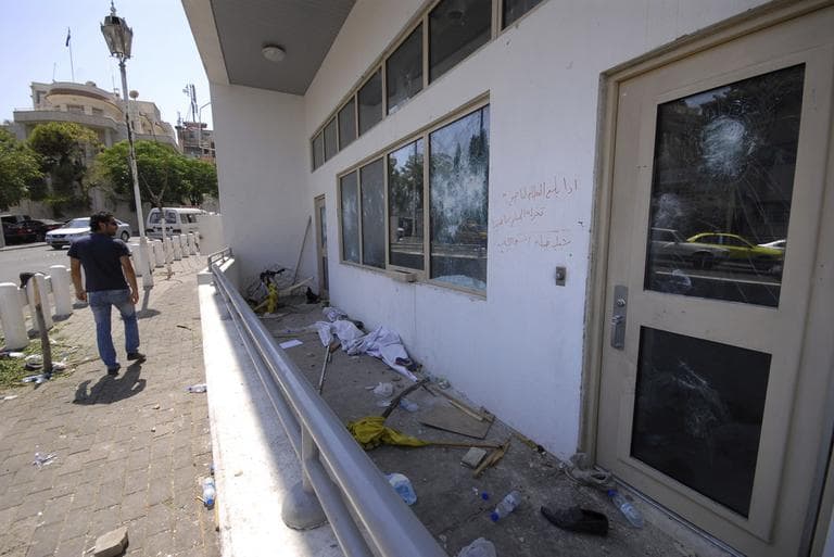 A man checks the damaged U.S. embassy after pro-government protesters attacked the embassy compound in Damascus, Syria, Monday, July 11, 2011. (AP)