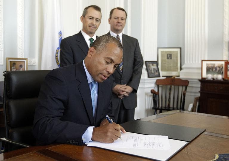 Massachusetts Gov. Deval Patrick signs the 2012 fiscal year budget in his office at the Statehouse on Monday. (AP)