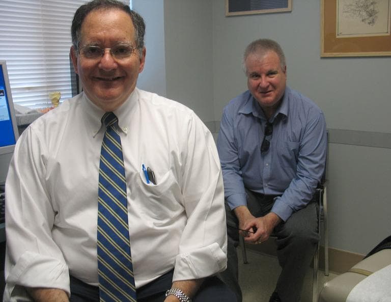 Dr. Alan Cole, left, and patient Alan Reiss discuss news ways to treat Reiss for diabetes. (Martha Bebinger/WBUR)