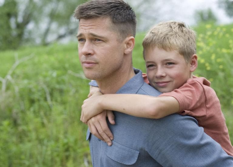 Brad Pitt, plays the father of three young boys in Terrence Malick's new film, &quot;The Tree of Life.&quot; Pictured here are Pitt and Laramie Eppler in a scene from the movie. (AP) 