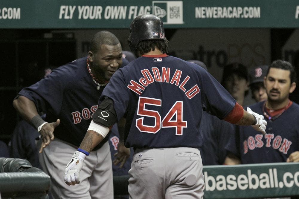 Red Sox&#39;s Darnell McDonald celebrates with teammate David Ortiz, left, and Adrian Gonzalez, right, after his second-inning home run. (AP) 