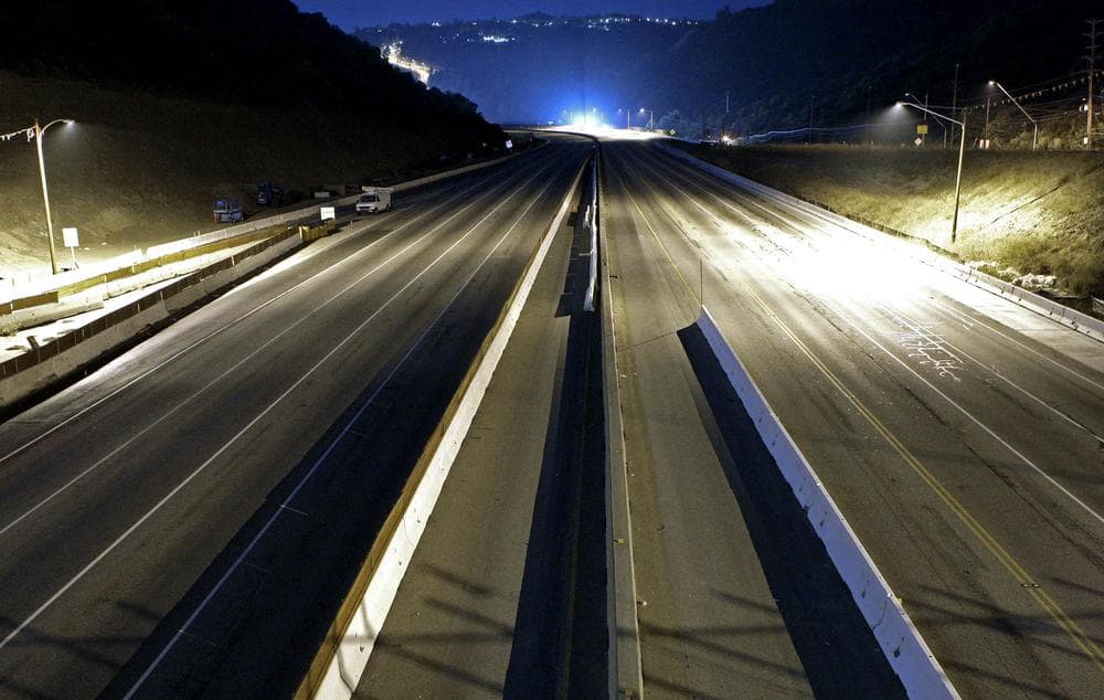 Interstate 405 is completely free of traffic, seen looking southbound from the Skirball Drive bridge, in preparation for the demolition of the Mulholland Drive bridge, just after midnight early Saturday morning. (AP)