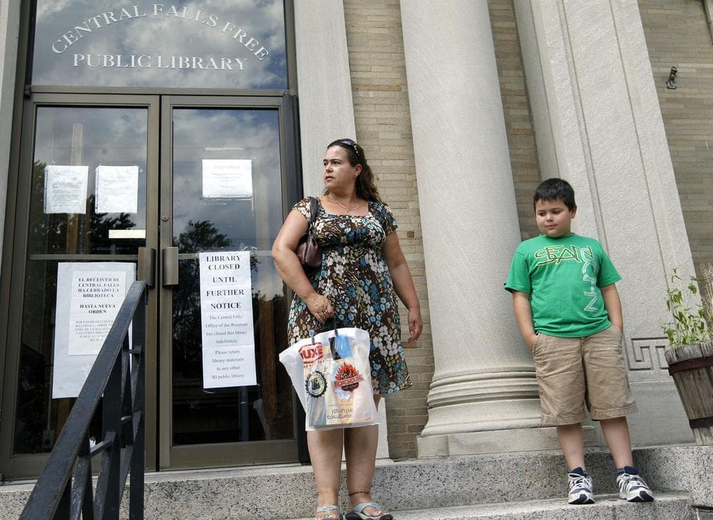 A mother and son try to return books to the library which is closed indefinitely in Central Falls, R.I. (AP)