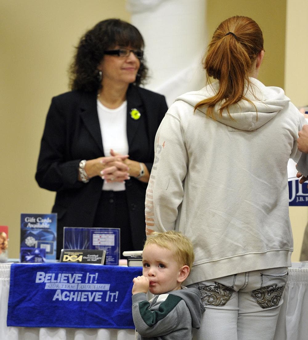 Xander Lee, 2, waits with his mother Amanda Lee as she searches for employment opportunities during a jobs fair in Rockford, Ill. (AP)