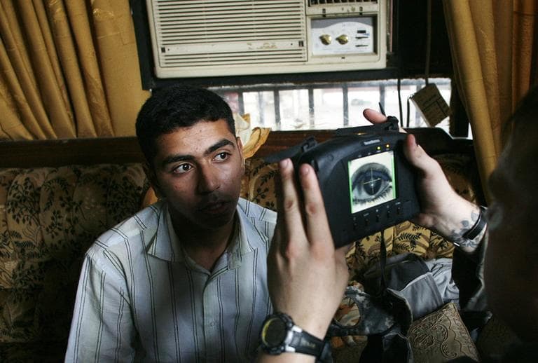 The U.S. military has been gathering biometric information for years. Here they are gathered in Iraq. Now, police departments are getting the same technology. (AP)