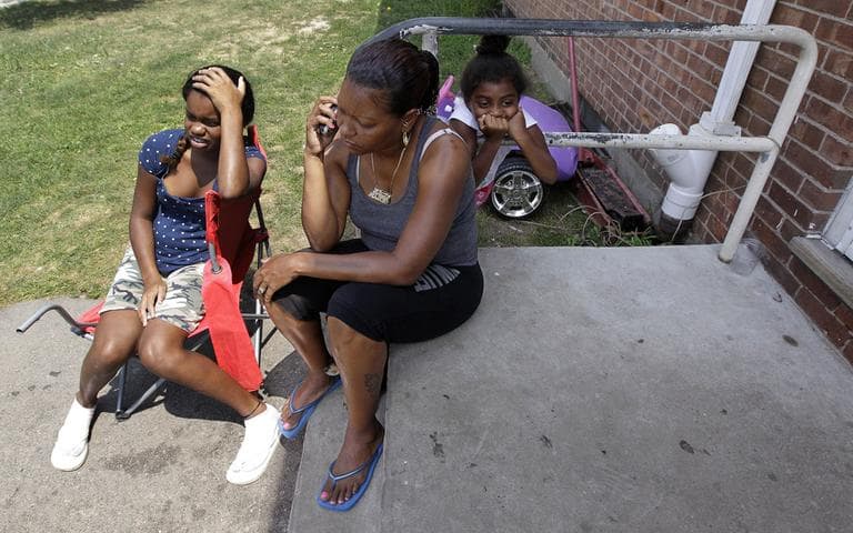 Kimberly Gambaro, 13, left to right, Maria Gonzalaz and Nani Gambaro, 5, sit outside their duplex in Mattapan in an attempt to escape the heat indoors, Thursday. (AP)