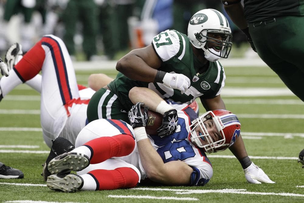 New York Jets' linebacker Bart Scott tackles Buffalo Bills' Jonathan Stupar.  Scott told a New Jersey paper that getting rid of two-a-day practices would make the NFL &quot;soft.&quot;  (AP)