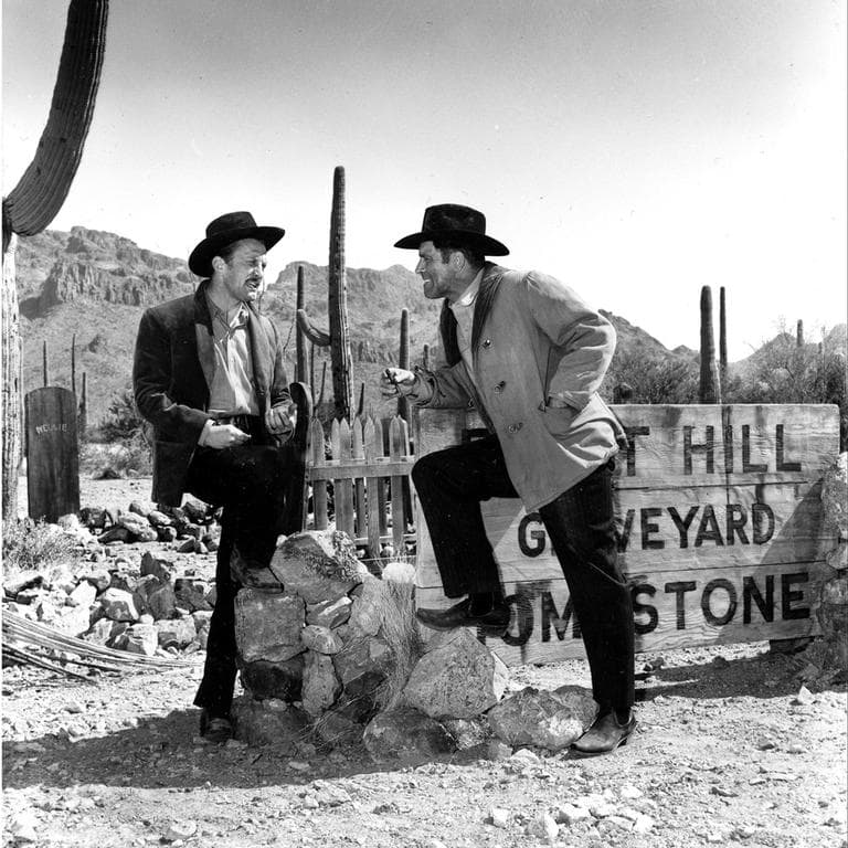 Co-stars Kirk Douglas, left, and Burt Lancaster talk between scenes on the set of the western &quot;Gunfight at the O.K. Corral&quot; in Hollywood, Ca., April 21, 1956. Lancaster plays the role of Wyatt Earp and Douglas portrays Doc Holliday. (AP)