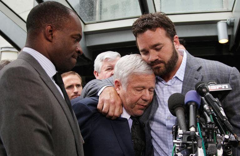 NFLPA Executive Director DeMaurice Smith, left, looks on as New England Patriots owner Robert Kraft is hugged by Jeff Saturday, of the Indianapolis Colts, during a Monday news conference after the players and 32 team reps voted unanimously to approve a new labor deal. (AP)
