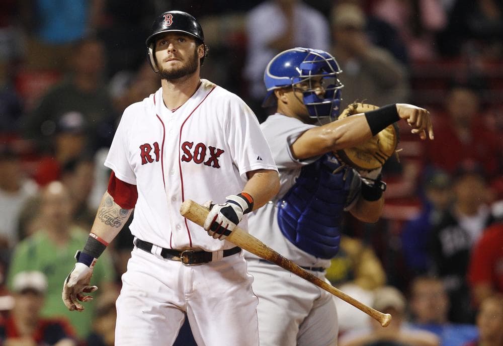 Boston Red Sox Josh Reddick walks back to the dugout after striking out against the Kansas City Royals in the 14th inning of a baseball game at Fenway Park in Boston, early morning on Tuesday. The Royals beat the Red Sox 3-1 in 14 innings. At right is Royals catcher Brayan Pena. (AP)