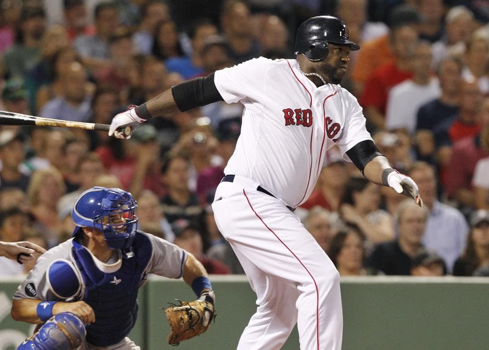 Boston Red Sox designated hitter David Ortiz follows through on a double scoring two runs as Kansas City Royals catcher Matt Treanor, left, watches during the third inning of the game on Tuesday in Boston. (AP)