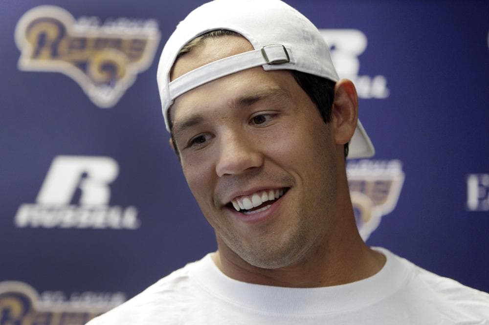 St. Louis Rams quarterback Sam Bradford looks happy to be back to work at a news conference on Tuesday.  (AP)