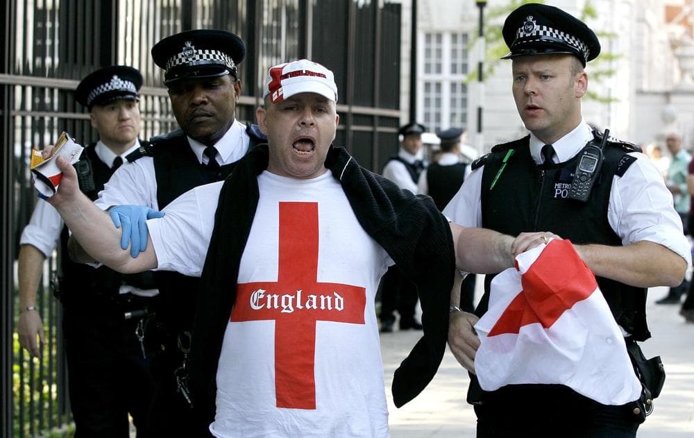 A supporter of the English Defence League is led away by police, during a counter protest to a pro-bin Laden rally outside the US Embassy in London. (AP)
