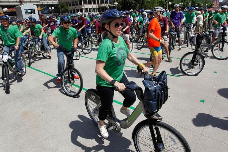 Boston's Tish Simmons, front, and other cyclists depart Boston's City Hall Plaza Thursday as part of a launch of the state's first bike-share program &mdash; Hubway. (AP)