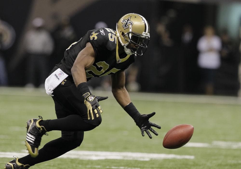Free agent running back Reggie Bush bobbles the ball during an NFL football game in January 2011. (AP)